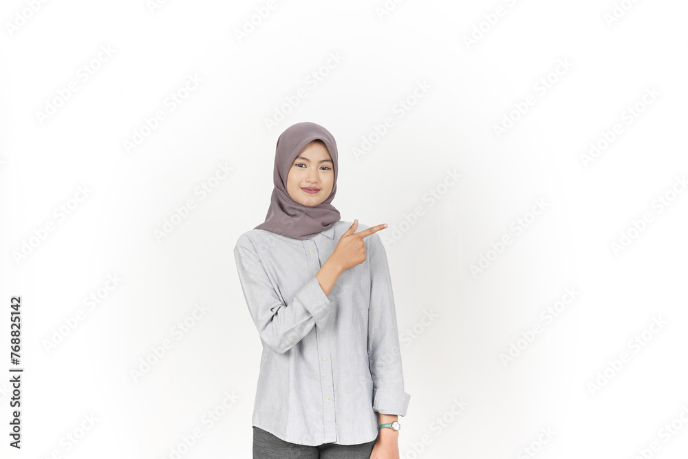 Young Asian woman wearing hijab Pointing side copy space isolated on white background Young Asian woman wearing hijab Pointing side copy space isolated on white background
