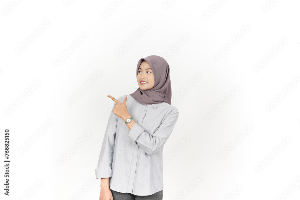 Young Asian woman wearing hijab Pointing side copy space isolated on white background
