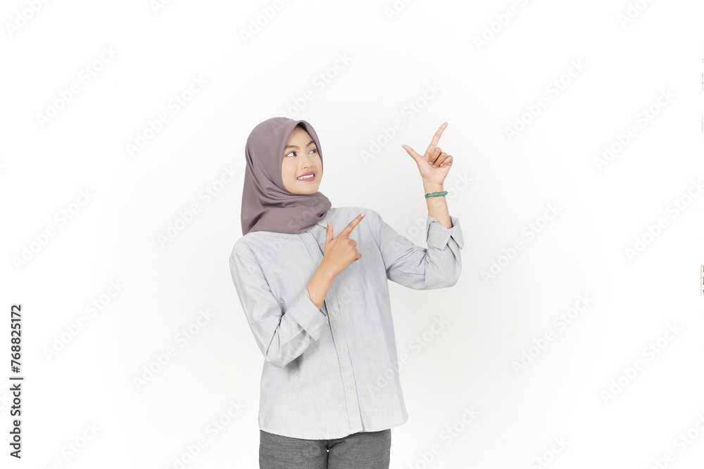 Young Asian woman wearing hijab Pointing side copy space isolated on white background Young Asian woman wearing hijab Pointing side copy space isolated on white background