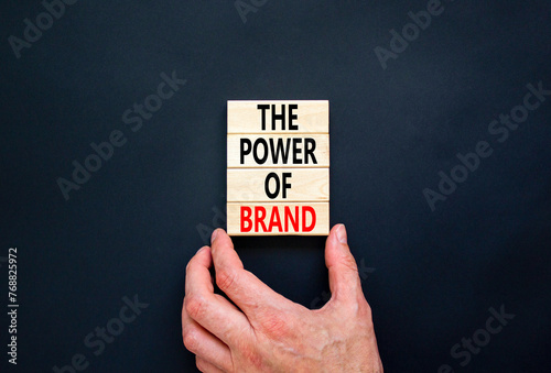The power of brand symbol. Concept words The power of brand on beautiful wooden block. Beautiful black table black background. Businessman hand. Business the power of brand concept. Copy space.