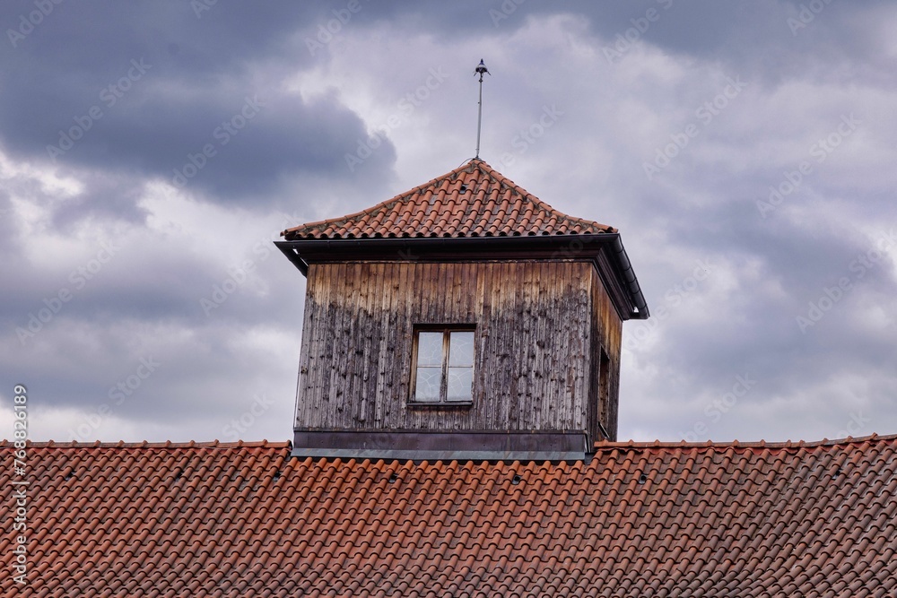 Windows of an old historic building on the backdrop of cloudy sky