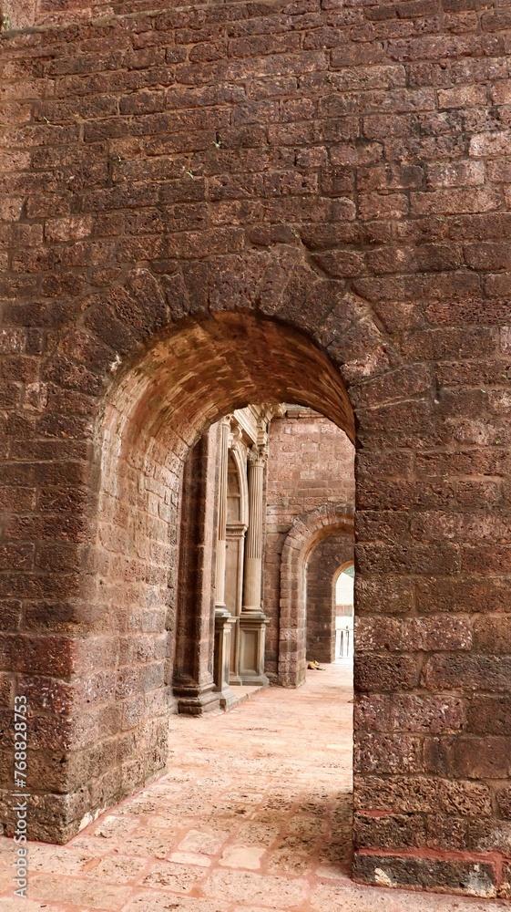 Traditional brick archway in a brick wall of an aged structure