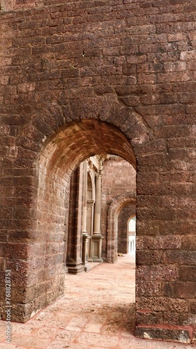Traditional brick archway in a brick wall of an aged structure
