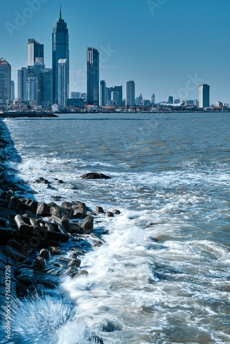 waves are on the seaside of the city photo