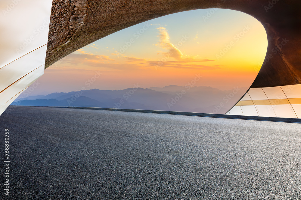 Asphalt highway and tunnel exit with mountain at sunset - obrazy, fototapety, plakaty 