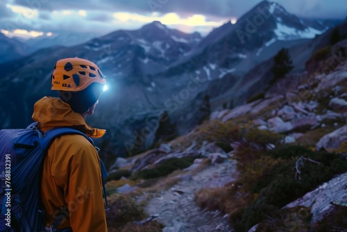 climber with headlamp looking at the mountain trail at dusk © studioworkstock