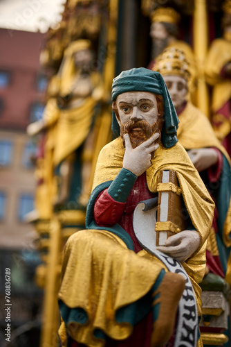 Life-size bronze statue of Jesus Christ is featured with a book in one hand