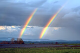 Rainbow After Spring Rain with Thunder: The Emergence of Sun and Clearing Rain Clouds Symbolizing the Changeable Weather of Spring