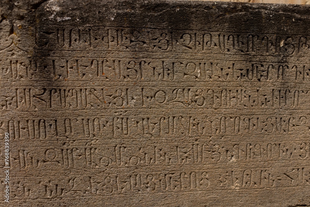 Old Armenian stone tablet featuring a weathered and faded inscription