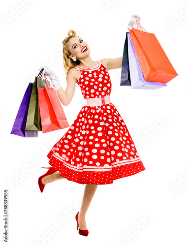 Full body jumping, running, dancing woman wear pinup red dress hold, show carry colorful shopping bags, isolated white background. Sales offer, rebates consumer bank credit ad advertise concept.