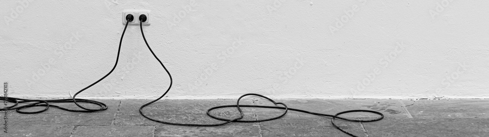 Grayscale shot of two electrical wiring in a hall