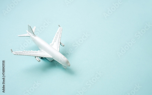 White airplane on the blue background. Vacation travel concept.