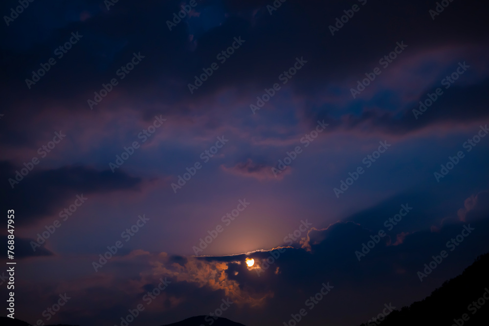 Moonlight in Cloudscape at Night in Lugano, Ticino, Switzerland.