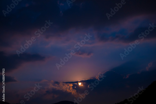 Moonlight in Cloudscape at Night in Lugano, Ticino, Switzerland.