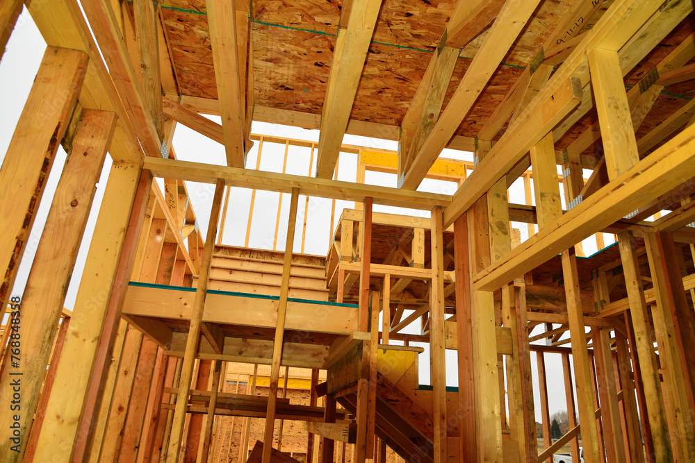 Interior wood framework of single family residential building under construction. Interior wood framework of single family residential building under construction.