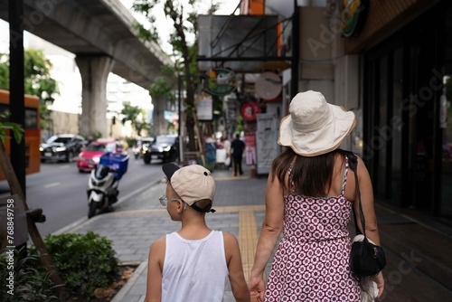 Mother and son walking in the Bangkok city  photo
