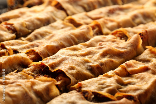Close up of homemade, delicious filo pastry dessert, tikvenik, filled with pumpkin, walnuts, cinnamon and sugar. Traditional Bulgarian cuisine.