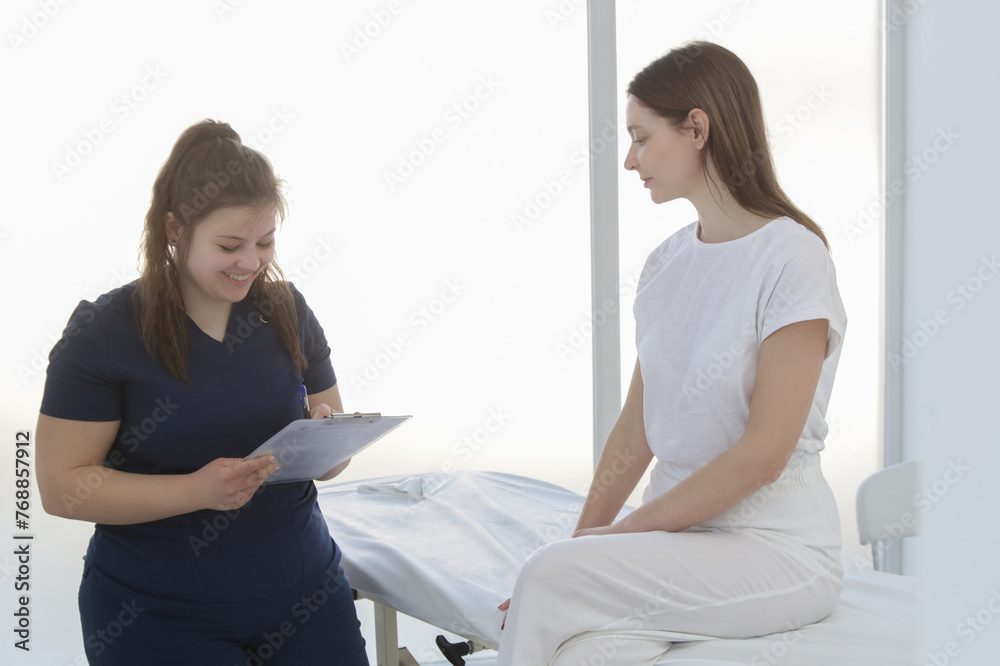 Woman at the doctors office on chiropractic, physiotherapy or myodynamic treatment to treat and prevent musculoskeletal problems, reduce pain and muscle tension. Woman at the doctors office on chiropractic, physiotherapy or myodynamic treatment to treat and prevent musculoskeletal problems, reduce pain and muscle tension.