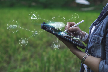 Reducing CO2 emissions and combat global warming and climate change. In nature using tablet planning new ideas and technology for eco-friendly solutions for a sustainable future.