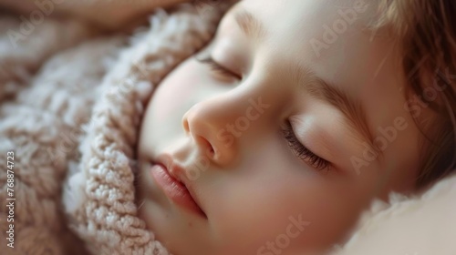 A close-up child's soft, sleeping face, their breath gently puffing out their pajamas photo