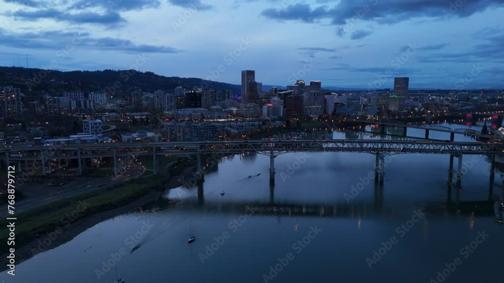 dusk view of Portland OR skyline flying backward over Tilikum Crossing Bridge