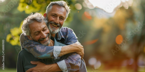 Portrait of mature gay men hugs on the street illuminated by the sun. LGBT elderly couple photo
