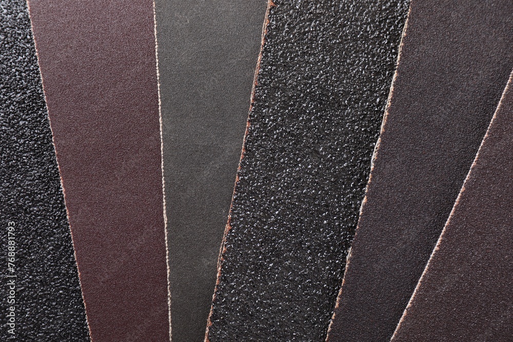 Fototapeta premium Many sheets of sandpaper as background, top view