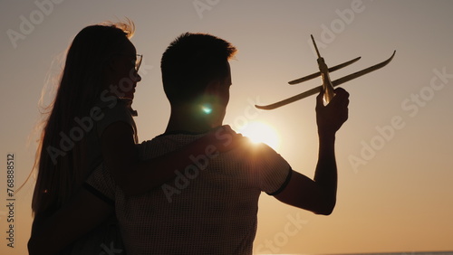 Man and child play with a toy airplane