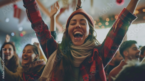 A woman exults with her arms raised amidst a jubilant crowd at a celebration photo