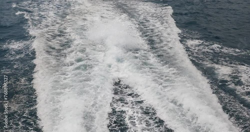 Ship wake up in the ocean. aves from the back of a speed boat over the water's surface in the sea. Waves behind a boat on a clear blue sea