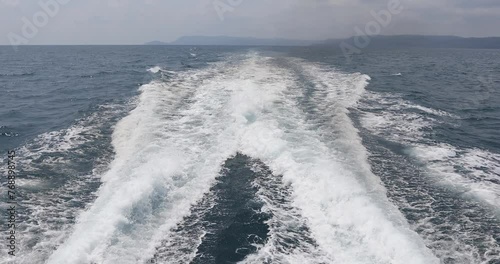 Ship wake up in the ocean. aves from the back of a speed boat over the water's surface in the sea. Waves behind a boat on a clear blue sea