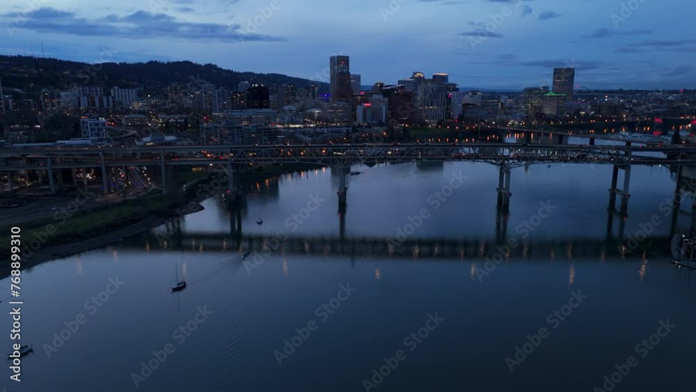 dusk view of Portland OR skyline curving backward over Tilikum Crossing Bridge dusk view of Portland OR skyline curving backward over Tilikum Crossing Bridge