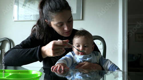 Mother feeding lunch to baby infant son