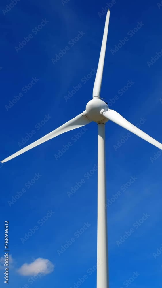 Green renewable alternative energy concept - wind generator turbine generating electricity in sky Green renewable alternative energy concept - wind generator turbine generating electricity in sky