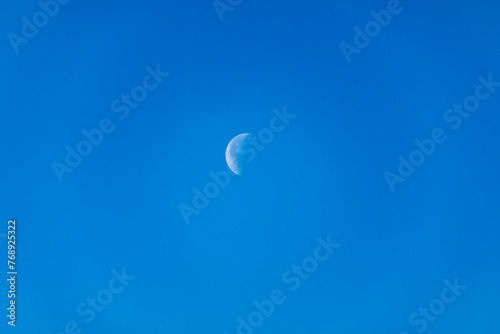 Waning Gibbous moon. A waning gibbous moon is a moon between full and last quarter, over blue sky