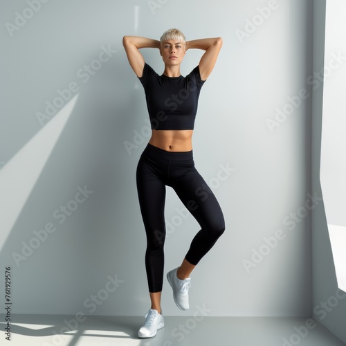 Attractive woman with a fashionable hairstyle in stylish sportswear. Fashion and beauty, active lifestyle and sports.