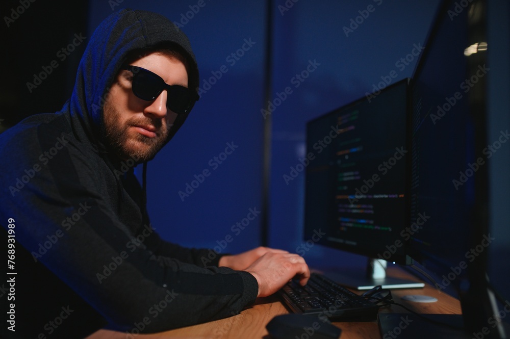 Wanted hackers coding virus ransomware using laptops and computers. Cyber attack, system breaking and malware concept Wanted hackers coding virus ransomware using laptops and computers. Cyber attack, system breaking and malware concept
