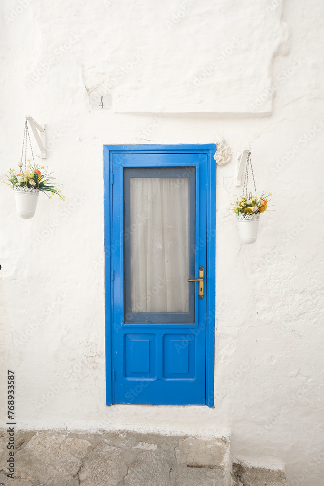 Fototapeta premium Charming blue door in puglia, Apulia, Italy