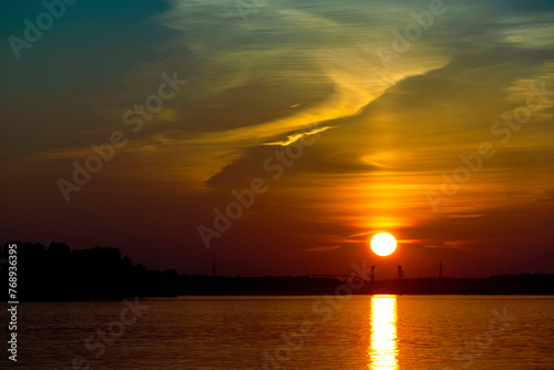 Golden sunset on the beach at neva river in saint-petersburg, russia. Tranquil scene. Nature background. Landscape. High quality photo