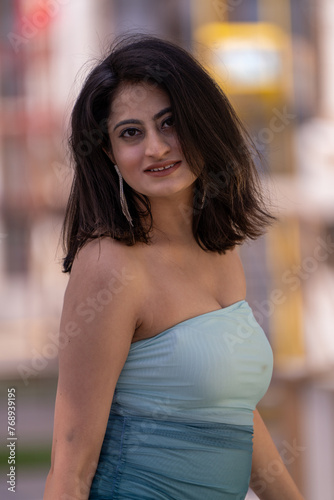 A woman in a blue dress is smiling for the camera Free Download A woman in a blue dress is smiling for the camera - GFXLoad