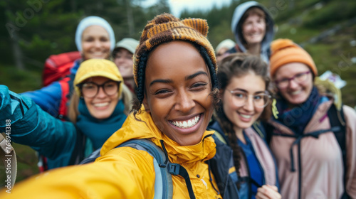 A diverse group of sporty women share laughs and smiles, group selfie and outdoor activities concept.