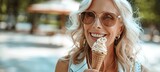 Senior woman savoring ice cream in city park with room for text, ideal for urban relaxation ads