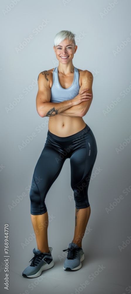 Athletic blonde woman with a short fashionable haircut in sportswear smiling on a white background. Fashion and beauty. Sports, active lifestyle, motivation, weight loss and fat burning. Athletic blonde woman with a short fashionable haircut in sportswear smiling on a white background. Fashion and beauty. Sports, active lifestyle, motivation, weight loss and fat burning.