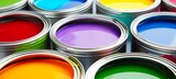 Assortment of open paint cans on colorful background with a variety of vibrant colors