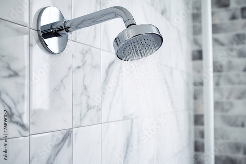 Chrome showerhead with water stream and marble wall