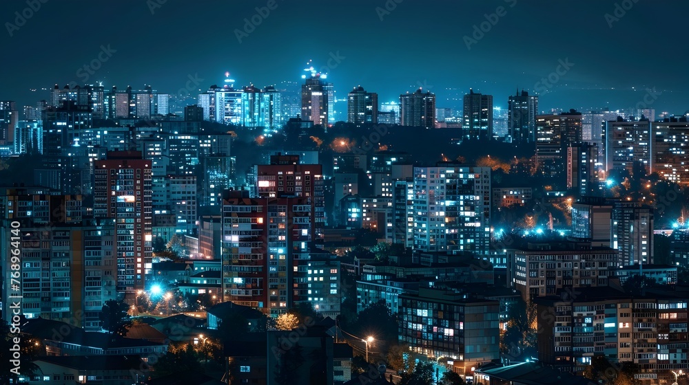 Blue-Lit Metropolis: Panoramic Night View of Illuminated Highrise Buildings and Residential Blocks in a Bustling City