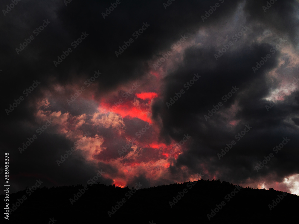 Beautiful sunset in the mountains. Dramatic sky with clouds.