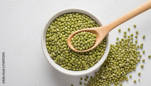 green mung beans with bowl and wooden spoon isolated on white background