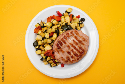 Delicious grilled chicken burgers served with baked vegetables