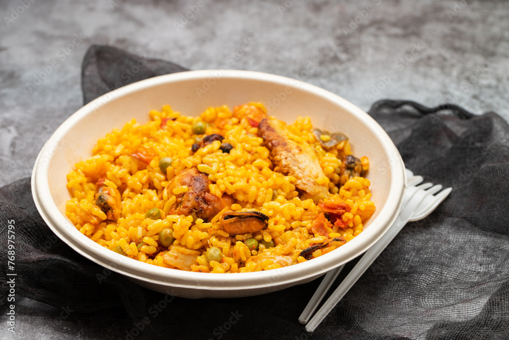 typicla spanish dish paella in plastic plate typicla spanish dish paella in plastic plate